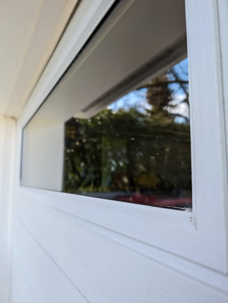 A sparkling clean window with no streaks, offering a crystal-clear view after a professional cleaning service.