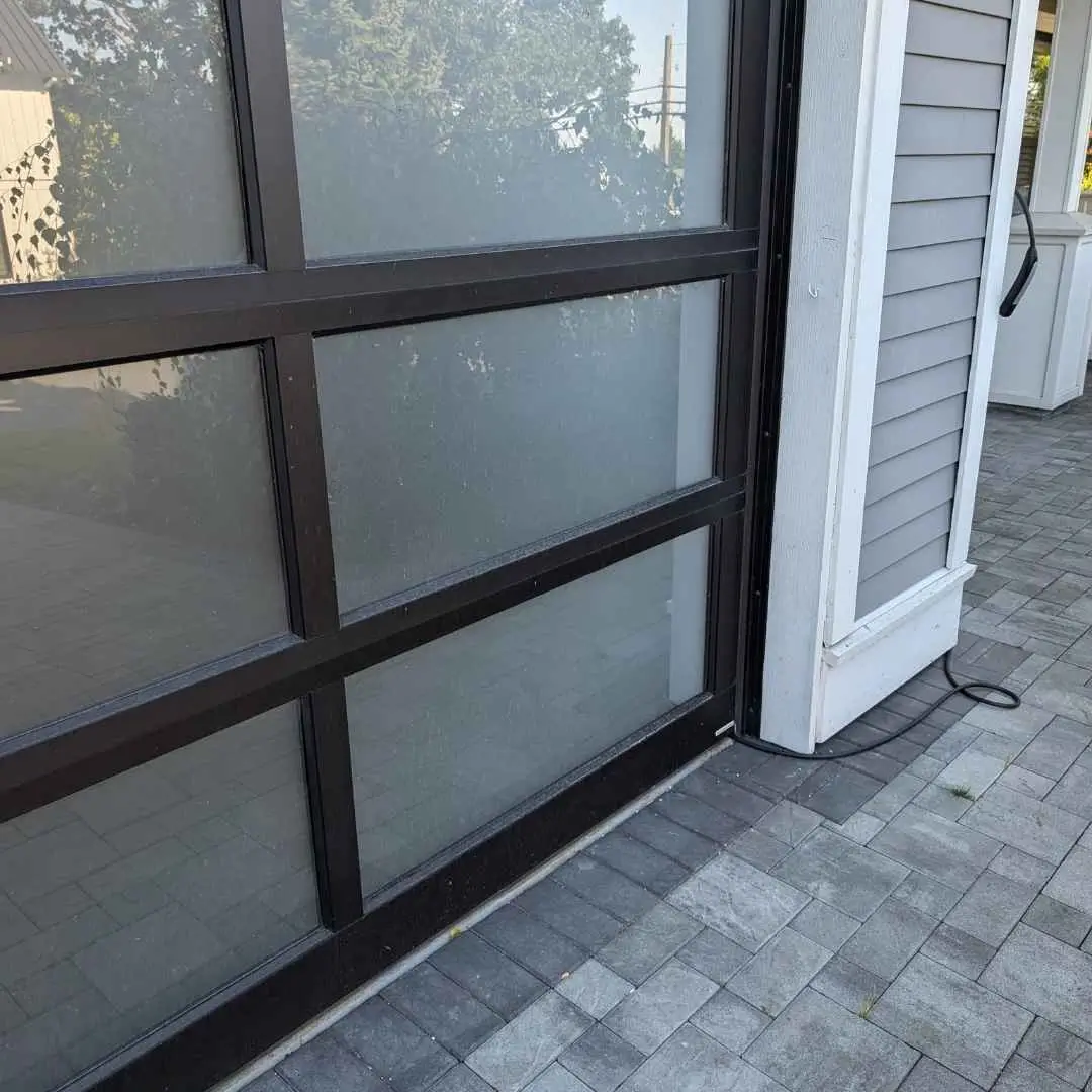 A freshly cleaned house exterior with sparkling sidings and driveway after professional pressure washing in Sidney.