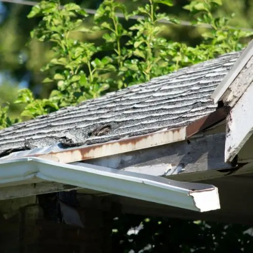 Damaged gutter joints with visible cracks, causing water to leak.