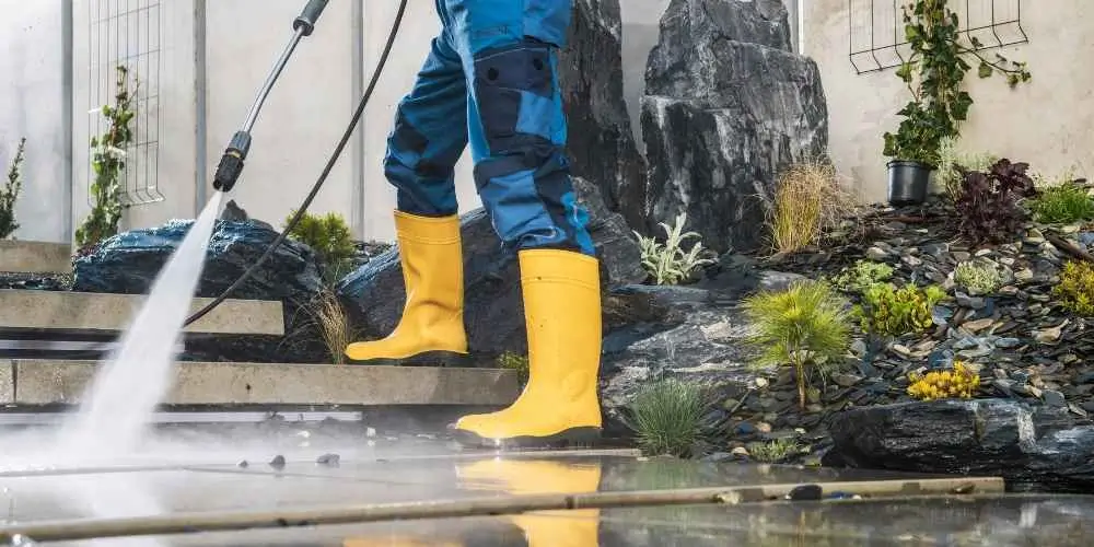 A professional using eco-friendly pressure washing equipment to clean a driveway efficiently and sustainably.