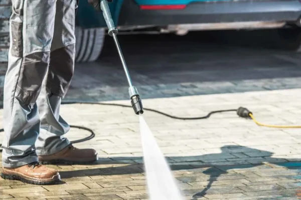 Eco-friendly pressure washing service cleaning a driveway with sustainable equipment and techniques.